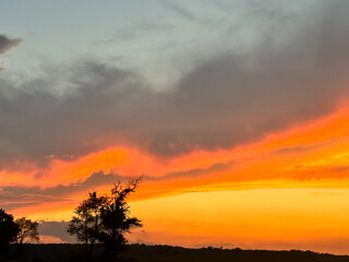 Band of fire in the sky sunset over a lonely, silhouetted sunset