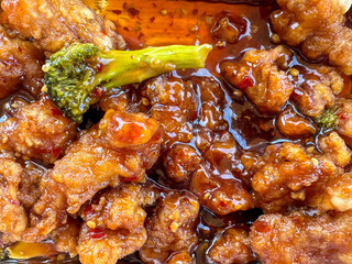 Closeup of General Tso’s Chicken in a takeaway container