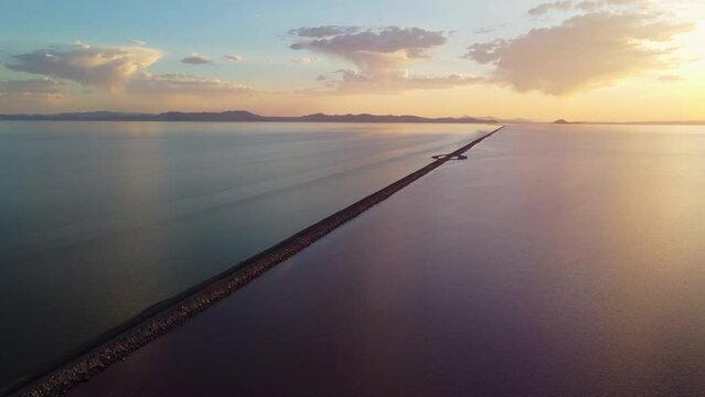 4k Aerial Views of Lucin Cutoff Divide Great Salt Lake Pink Water