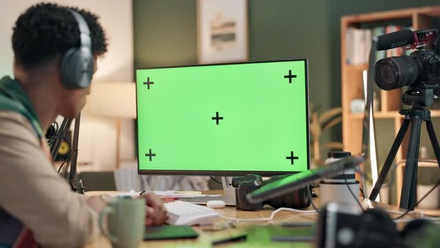 Green screen, computer and man in home office, working and editing for online video, podcast and project. Influencer, editor and internet with digital, program or software mockup for content creation