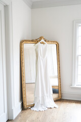 Wedding gown hanging on a mirror