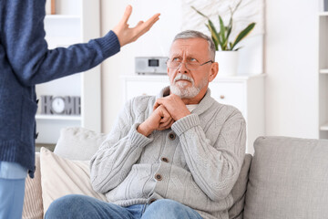 Female caregiver mistreating senior man in nursing home