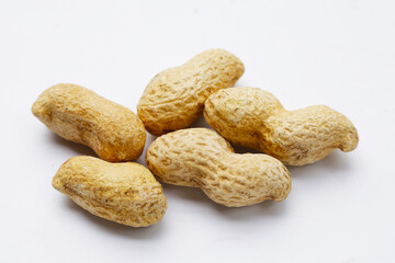 Roasted peanuts in shell on white background.