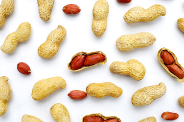 Roasted peanuts in shell on white background.