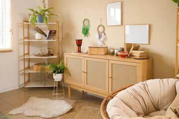 Interior of living room with witch's magic attributes, commode and shelf unit