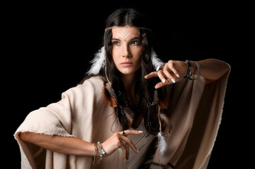 Beautiful female shaman on dark background