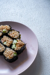 sushi rolls on a pink plate