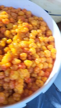 ripe juicy yellow cloudberry berries in buckets close-up