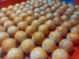dry cookies (in Indonesia called semprit cookies) on a baking sheet after being baked, ready to be packaged, usually produced in large quantities during Eid al-Fitr in Indonesia