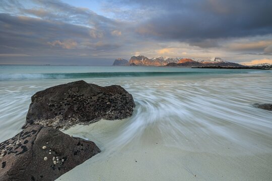 Rocks and beach in front of Bergen, sea, surf, spray, clouds, winter, Flakstadoya, Lofoten, Norway, Europe