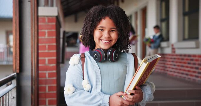 Face, girl and student with book in outdoor for learning, education and development as learner in school. Female child, headphones and smile for growth, skills and scholarship in literacy or numeracy