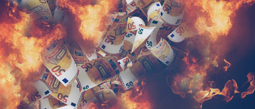 fire and flames and 50 euro banknotes as money and banknotes on the concept of inflation and burning money, interest and inflation rate or corruption and wasting money