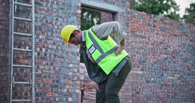 Accident, back pain and architect man with joint, injury and spine inflammation from arthritis. Construction worker, hurt and tension from manual labour for male person and medical emergency on site