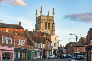 Newport Pagnell high street with tower of  St Peter and St Paul's Church. Buckinghamshire. England