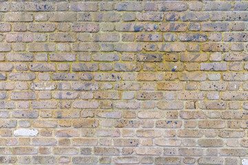 Beige grunge weathered brick wall, abstract full frame background texture with old dirty and vintage style pattern