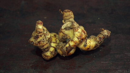 Galangal on a wooden table, focus selected