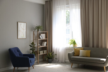 Stylish furniture and elegant curtains in living room. Interior design