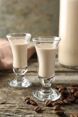 Coffee cream liqueur in glasses and beans on wooden table