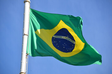Flag of Brazil fluttering in the wind. In the center of the flag with the words "order and progress" in Portuguese. flag day. proclamation of the Republic. proclamação da república
