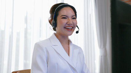 Businesswoman wearing vivancy headset working in office to support remote customer or colleague. Call center, telemarketing, customer support agent provide service on telephone video conference call