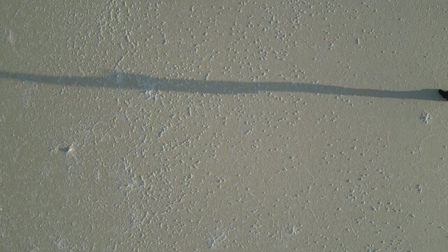 4K30 Shadow of Peraon Walking on Dry Salt Lake in Australia