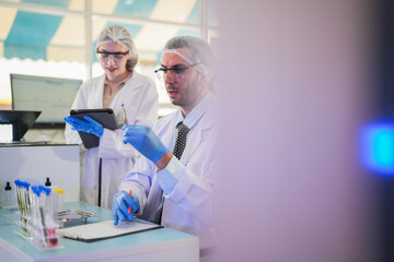 esteemed scientists elegantly dressed in lab coats are meticulously testing chemicals innovative...