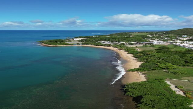 Flying above a tropical sandy beach in Rincon, Puerto Rico in the Caribbean