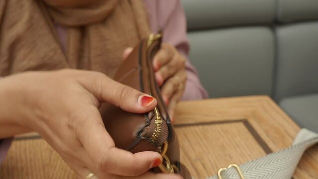 women taking smart phone our from her casual purse 