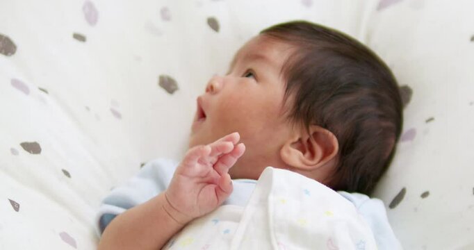 New born baby strangely surprised by lights when waking up