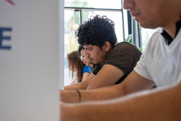 hispanic man at the voting booth station, diverse group of people in the us election, concept of democracy in USA united states of america presidential election 2024