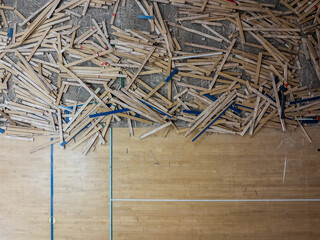 Removal of an old wooden plank gymnasium floor as part of a gym renovation project.