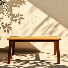 Empty wood table top on beige wall texture with tree leaves shadow background