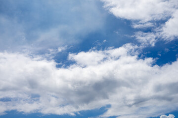 Naklejka premium white clouds on a blue sky background