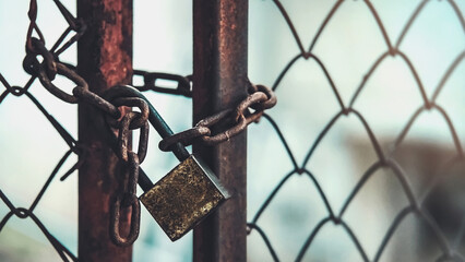 The iron gate was locked. Padlock with rusty metal chain. Private places. No entry. Abandoned house.