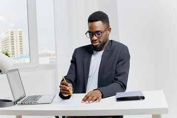 Fototapeta premium Businessman in formal suit preparing to sign important document at office desk with pen and paper