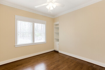 Bright Empty Office With Large Window, Hardwood Floor, And Ceiling Fan