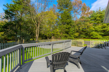 Summer Deck Area With Chairs, Surrounded By Green Backyard Scenery
