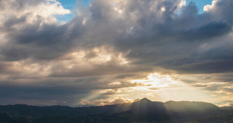 Scenic view dramatic beautiful sunset sky. Natural Sunset Sunrise on meadow silhouette shadow dark land. Vibrant dramatic sky on sunset, dawn, sunrise in Countryside. Landscape Colorful Sky At Sunset