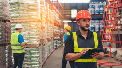 Hispanic men worker check stock control in distribution storage. Teamwork shipment worker checklist...