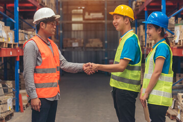 Asian Teamwork Warehouse worker shakehand together. Engineer man, women hands partnership. Coworker colleague logistics Warehouse teams handshake. Support team person teamwork partner logistics team