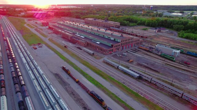 Sunset Aerial Railroad Hub Logistics in East Moline, Illinois: Freight Trains and Industrial Landscape