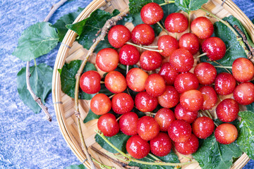 Red Cherry fruit in bamboo basket on on wooden background, Japanese Red highest variety of cherries on wooden table.