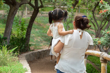 Family members holding hands while walking in a park during a sunny day in Lima Peru