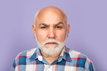 Fototapeta premium Face of 50s aged pensioner. Closeup emotional portrait of an old mature senior man with grey beard isolated on studio background. Emotions faces.
