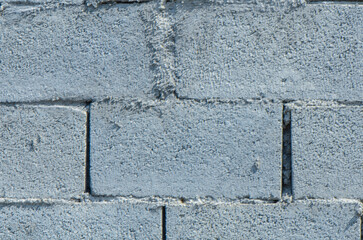 old gray cement background with cinder block wall