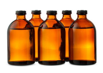 Five Amber Glass Bottles With Liquid on White Background