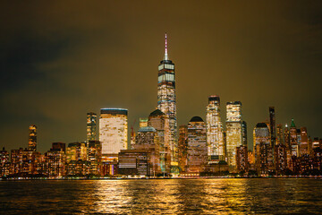 Obraz premium Night in The NYC city, USA, United States. Night day with iconic buildings. New York City NYC Manhattan Downtown Skyline, viewed from Jersey City, USA.