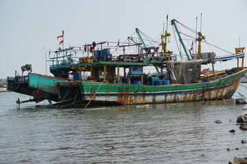 View of a group of fishing boats docked on the edge of the Jepara sea. Jepara, Indonesia