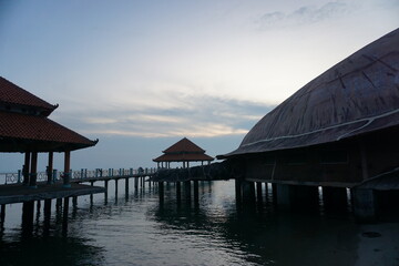 The large turtle statue on the edge of Kartini beach is one of the iconic landmarks in the city of Jepara. silhouette at sunset.
