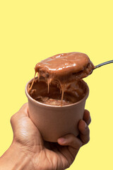 Spoonful of Alfajor dipped in dulce la leche.